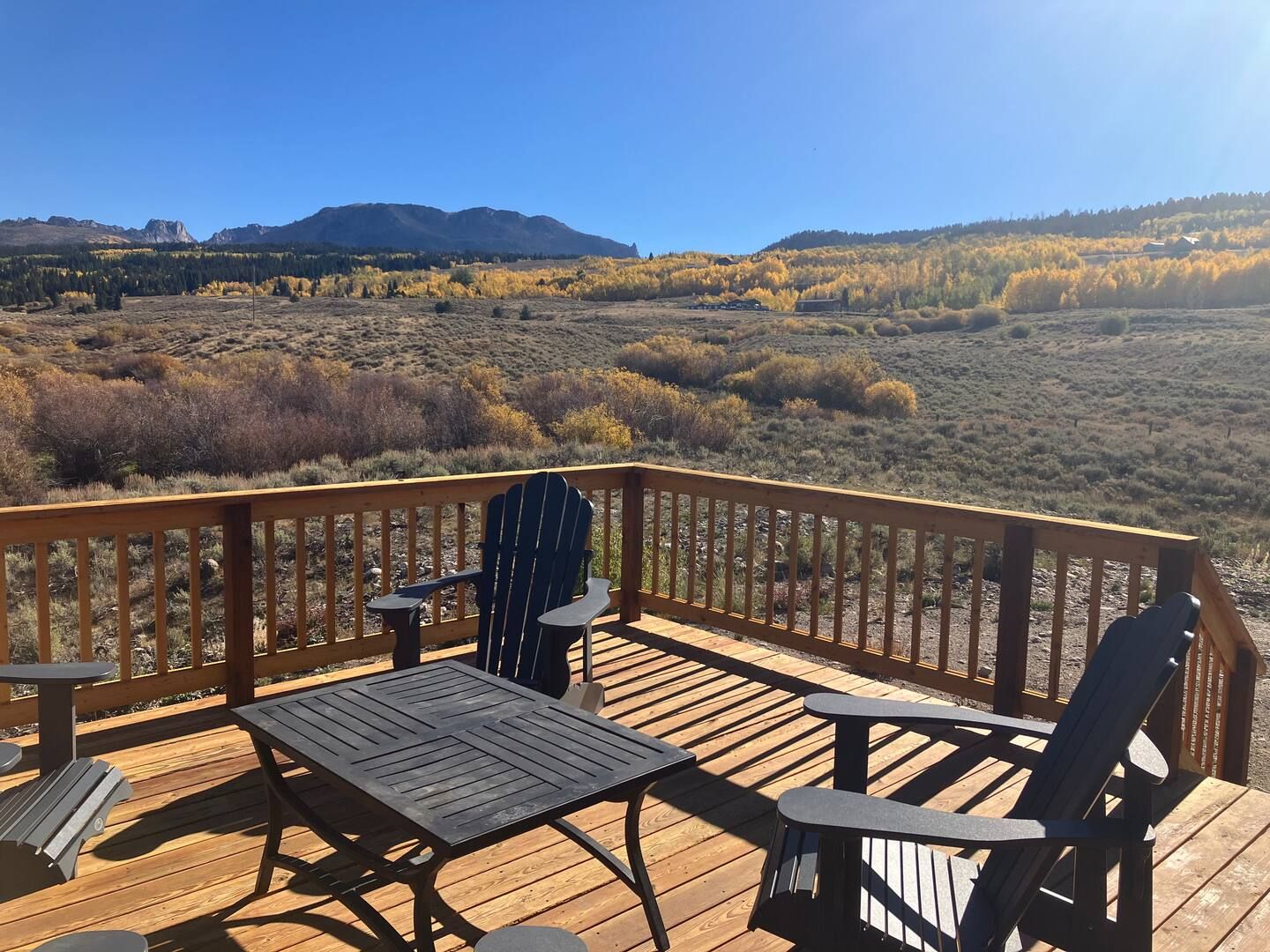 Chairs on the deck above gold aspens