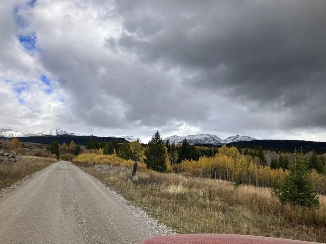 Gravel road, first snow on the range